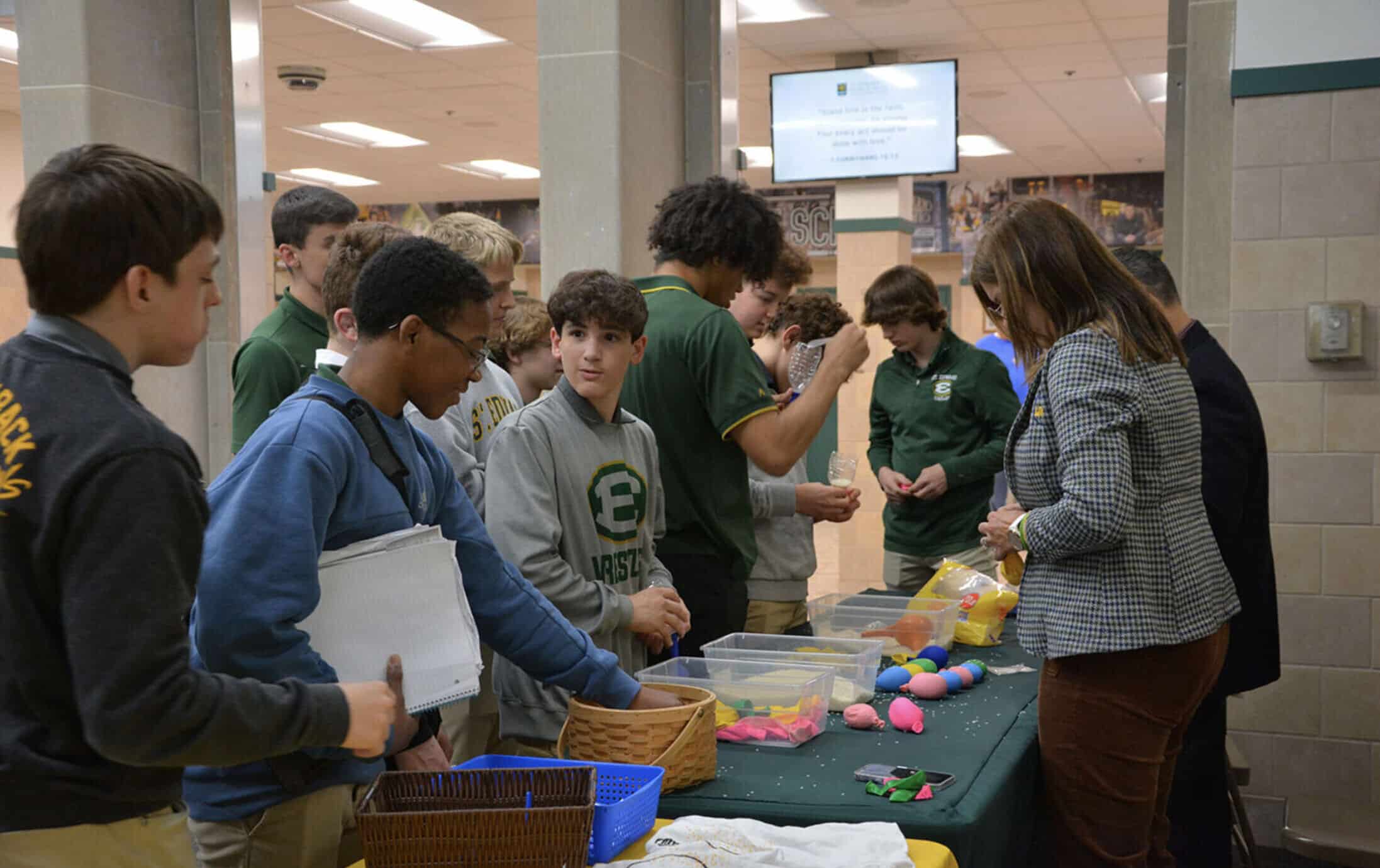 Students gathered at a table with crafts